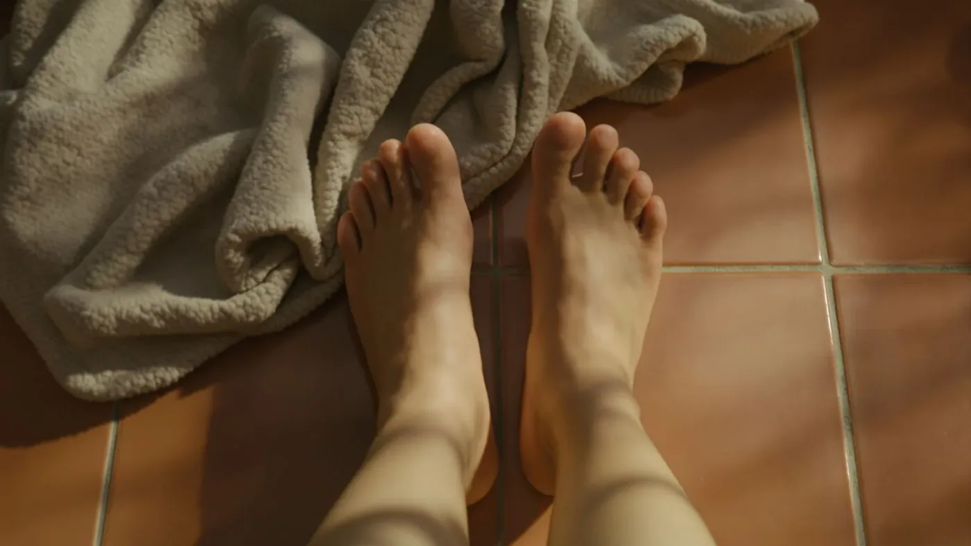 Bare feet resting on terracotta floor beside folded blanket for a 12-minute burnout reset