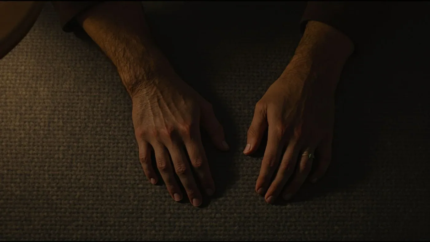 Man lying on bedroom floor with palms down practicing body-first self-compassion when shame is loud at night