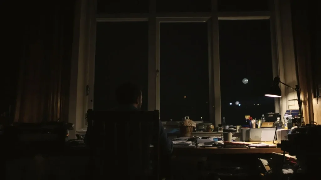 Man sitting alone at desk at night wondering why do I feel like everyone hates me