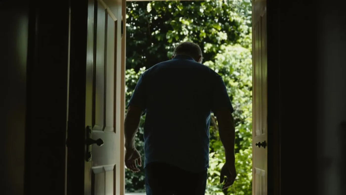 Man stepping through open doorway into daylight showing how long does burnout recovery take with realistic hope