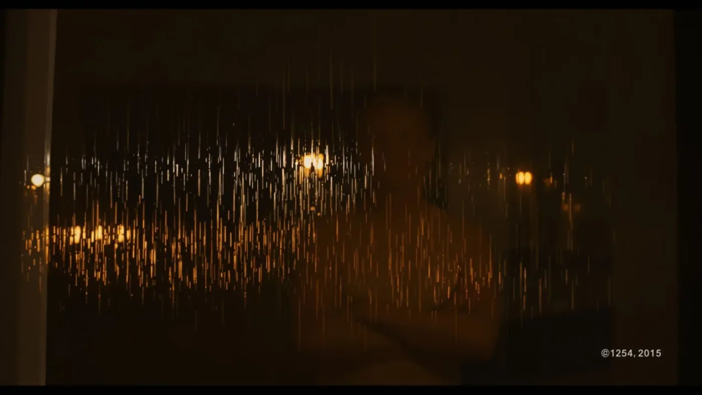 Person's body reflected in rain-streaked window at dusk, the hidden blocker of safety under pressure visible